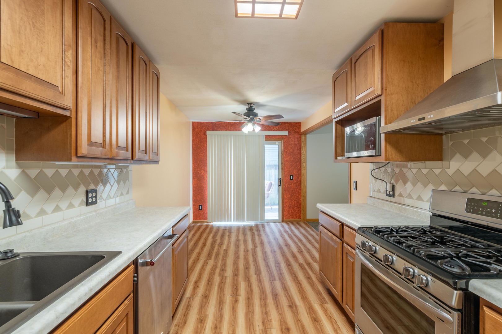 215 Fernwood Road Montgomery, IL 60538 - Photo 5 of 18 a kitchen with granite countertop stainless steel appliances a sink stove top oven and cabinets