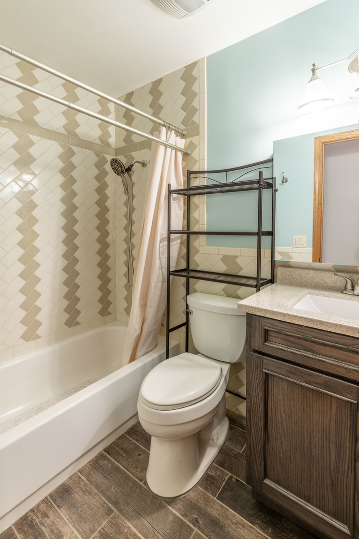 215 Fernwood Road Montgomery, IL 60538 - Photo 10 of 18 a bathroom with a sink toilet and shower
