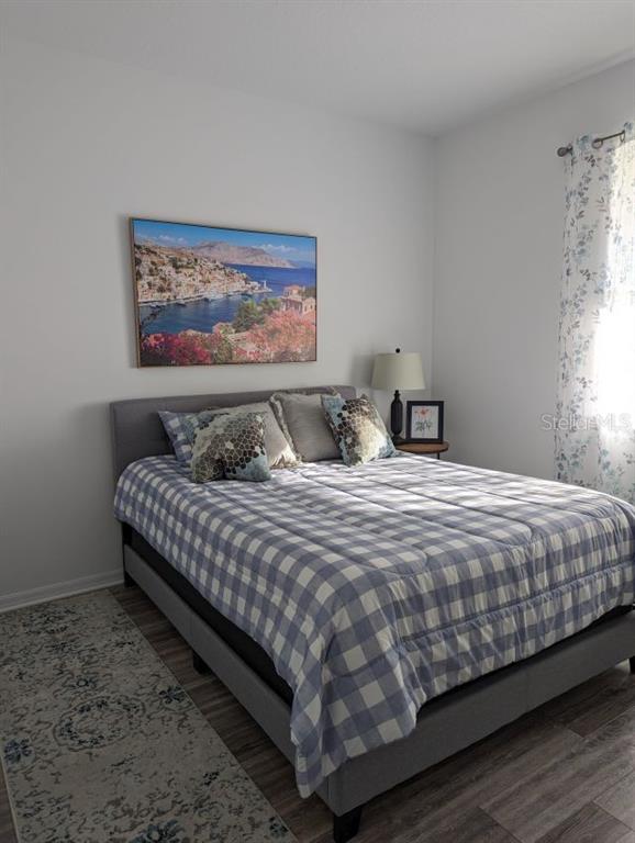 9045 Southwest 78th St Road Ocala, FL 34481 - Photo 14 of 21 a bedroom with a bed and painting on the wall