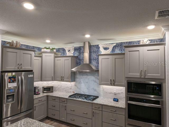 9045 Southwest 78th St Road Ocala, FL 34481 - Photo 8 of 21 a kitchen with a refrigerator and a stove top oven