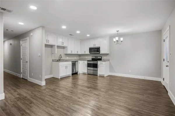 a view of kitchen view wooden cabinets and stainless steel appliances