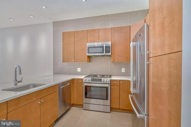 a kitchen with a sink and a refrigerator