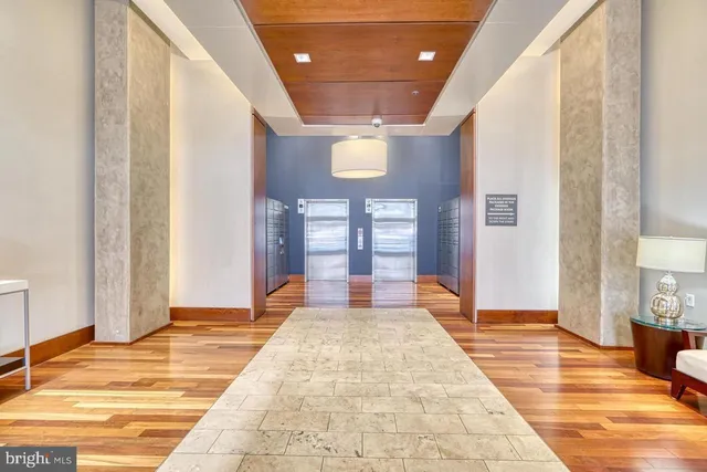 a spacious bedroom with a large bed and a chandelier