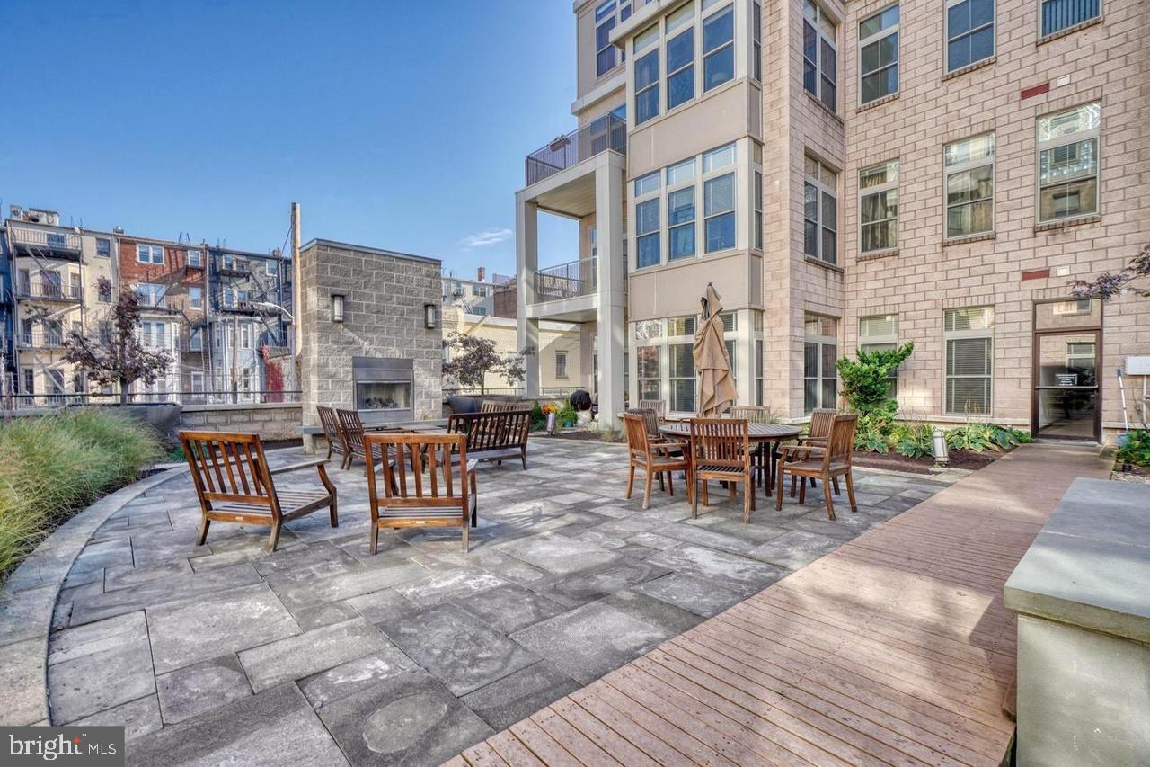 1209 North Charles Street, Unit 309 Baltimore, MD 21201 - Photo 10 of 11 a view of a patio with a table and chairs