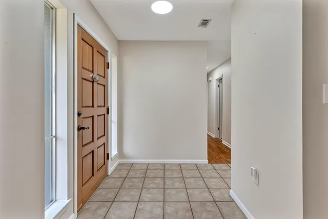 a view of a room with wooden floor and windows