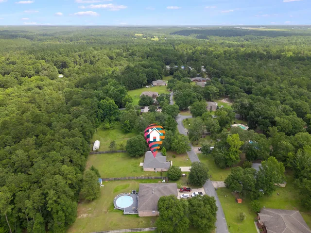 a view of a backyard with large trees