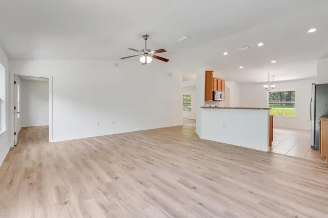 a view of a kitchen with a dishwasher and wooden floor