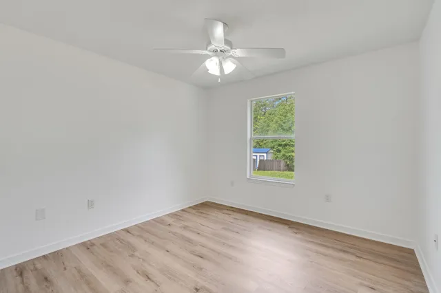 a bathroom with a granite countertop sink toilet and a mirror