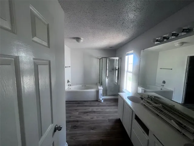 a large white kitchen with a stove and a refrigerator