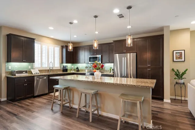 a large kitchen with a table and chairs