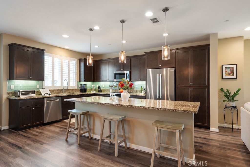 a large kitchen with a table and chairs