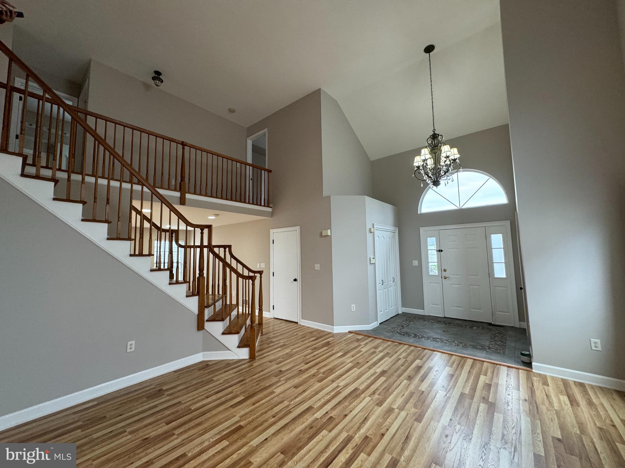 27 Yorkshire Village Road Lawrenceville, NJ 08648 - Photo 12 of 32 a view of a room with wooden floor staircase and a chandelier