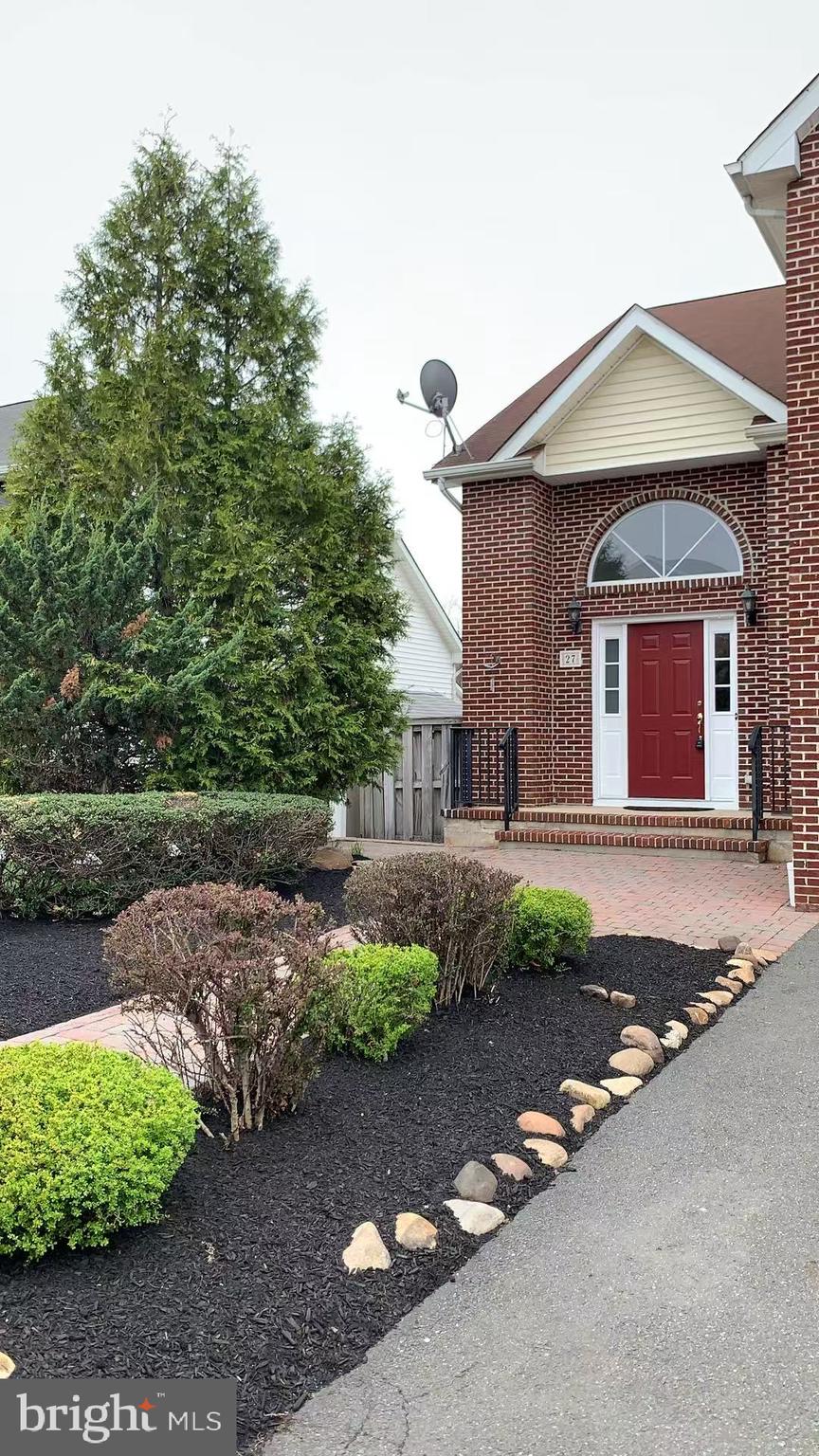 27 Yorkshire Village Road Lawrenceville, NJ 08648 - Photo 2 of 32 a front view of a house with a yard