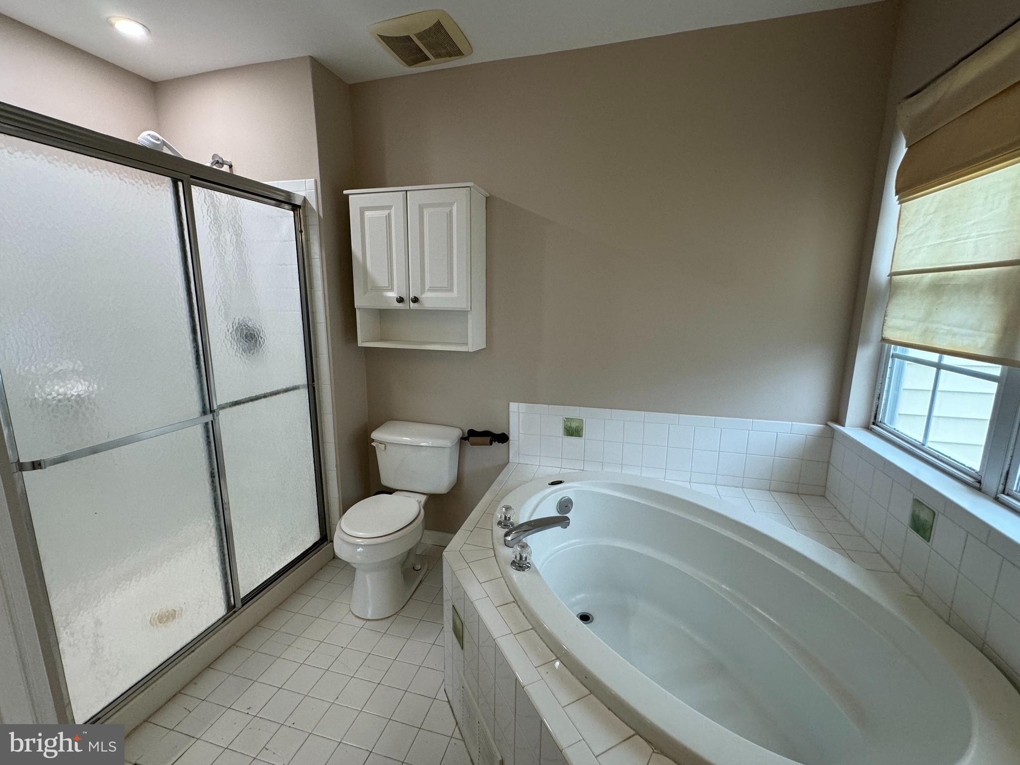 27 Yorkshire Village Road Lawrenceville, NJ 08648 - Photo 22 of 32 a bathroom with a tub toilet and window