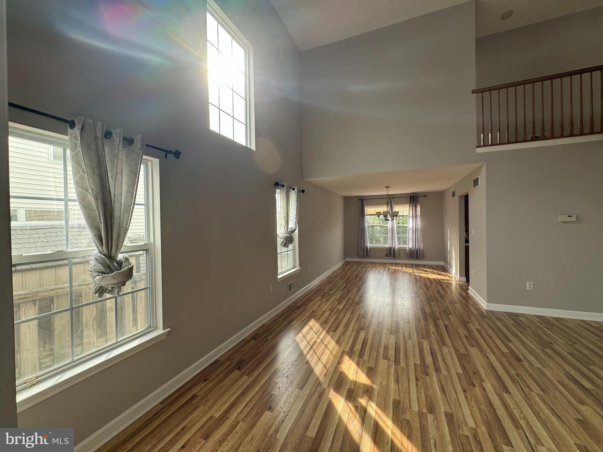 27 Yorkshire Village Road Lawrenceville, NJ 08648 - Photo 3 of 32 a view of an empty room with wooden floor and a window