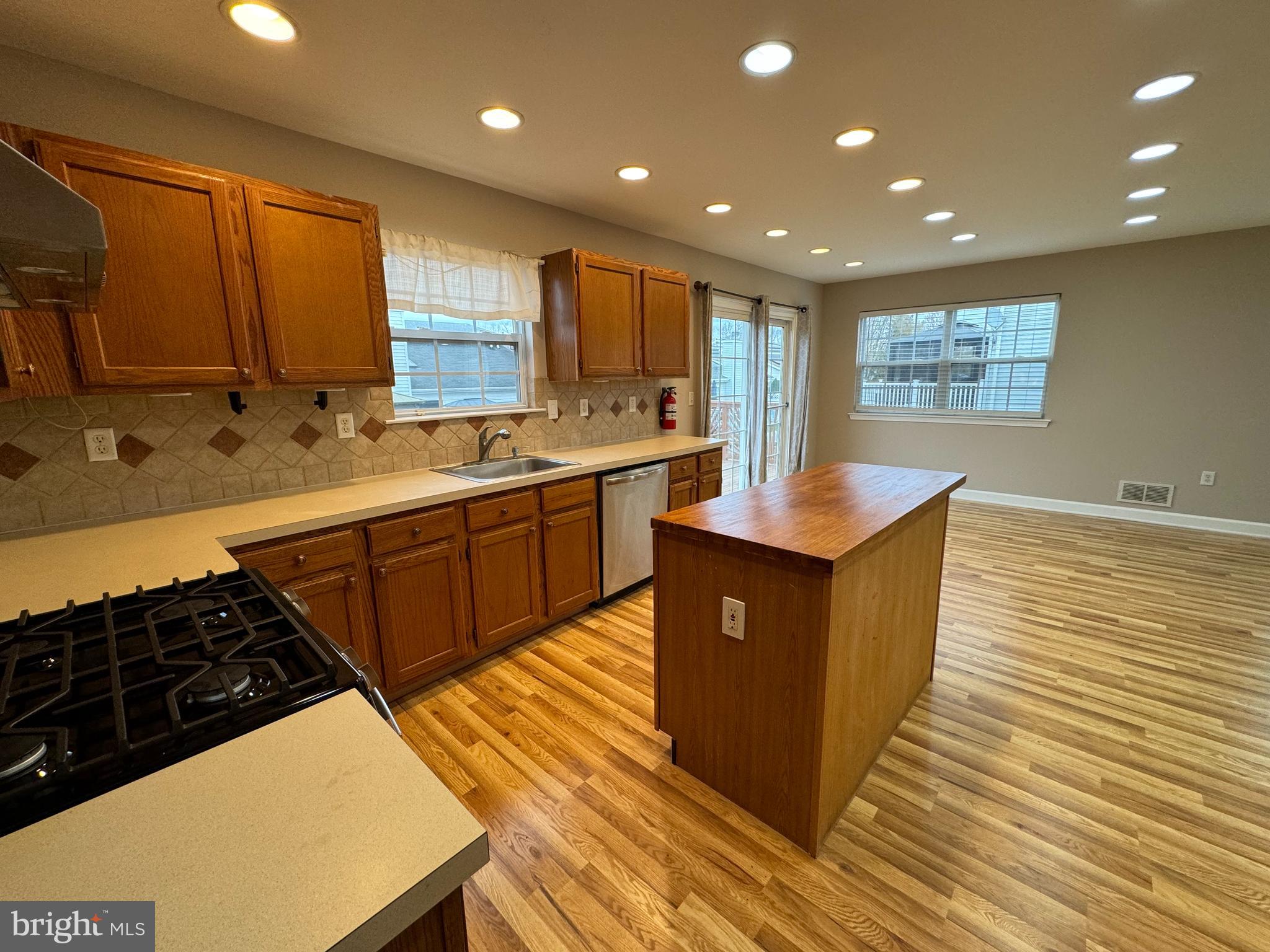 27 Yorkshire Village Road Lawrenceville, NJ 08648 - Photo 7 of 32 a kitchen with stainless steel appliances a sink stove and cabinets