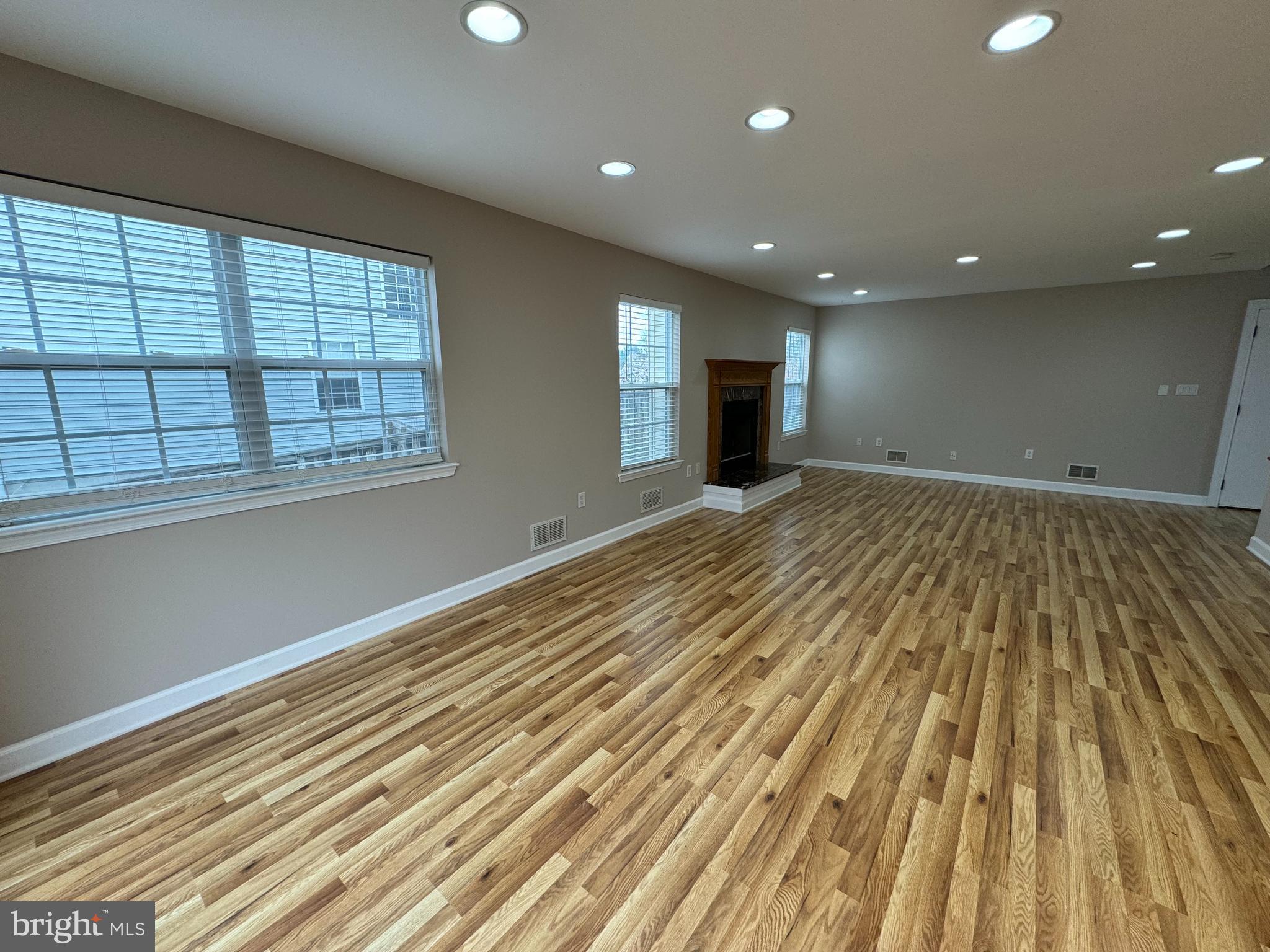 27 Yorkshire Village Road Lawrenceville, NJ 08648 - Photo 9 of 32 a view of an empty room with wooden floor and a window
