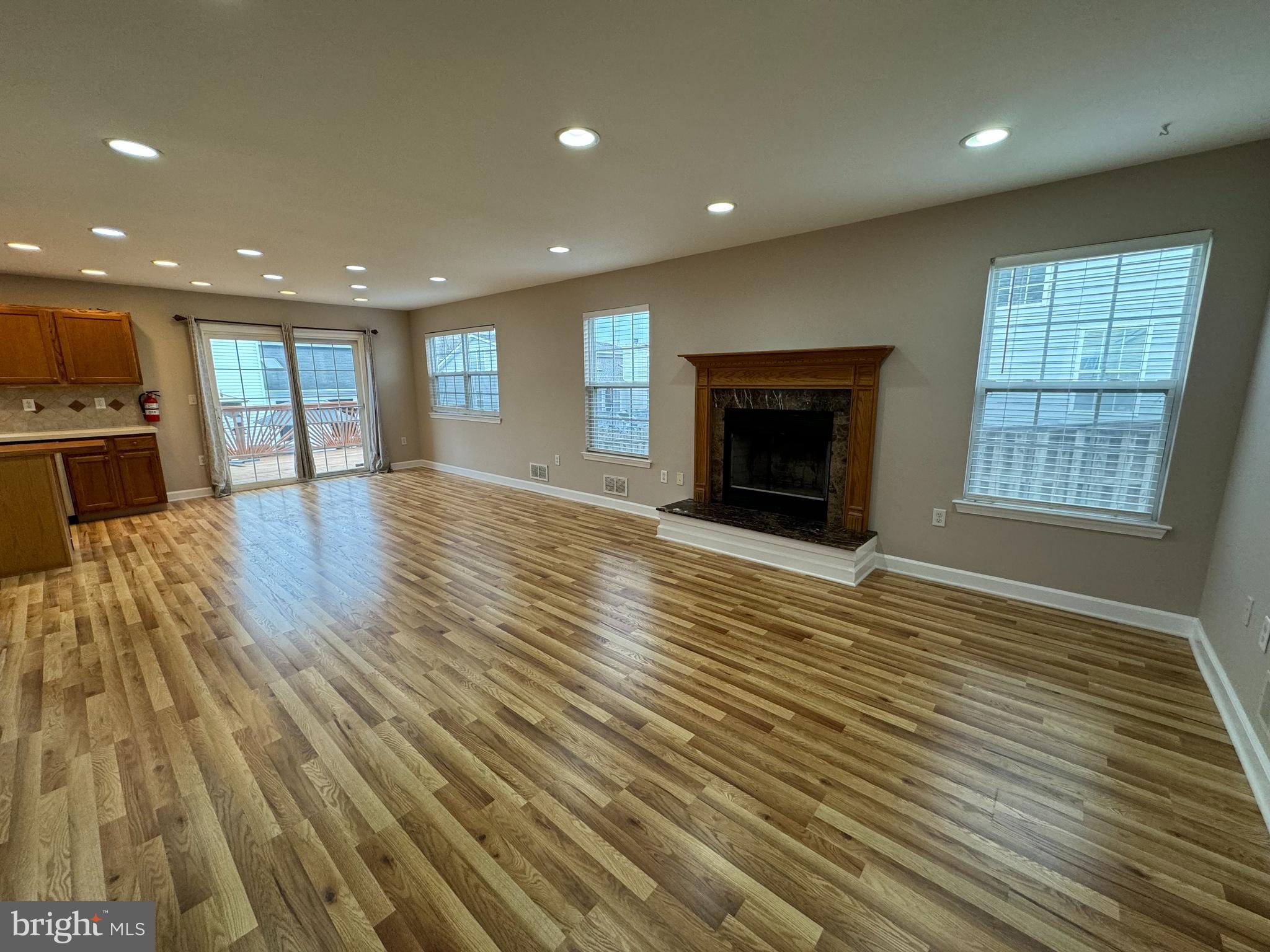 27 Yorkshire Village Road Lawrenceville, NJ 08648 - Photo 10 of 32 an empty room with wooden floor fireplace and windows