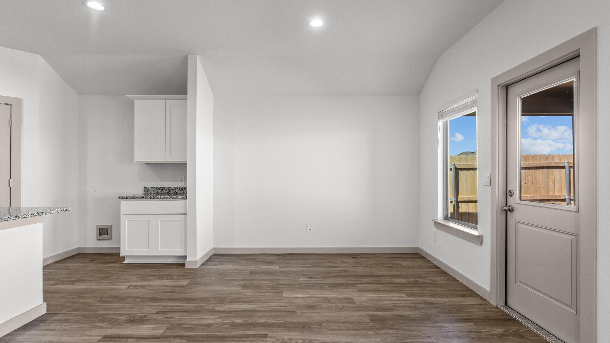 2301 150th Place Lubbock, TX 79423 - Photo 7 of 17 a view of a refrigerator in kitchen and wooden floor