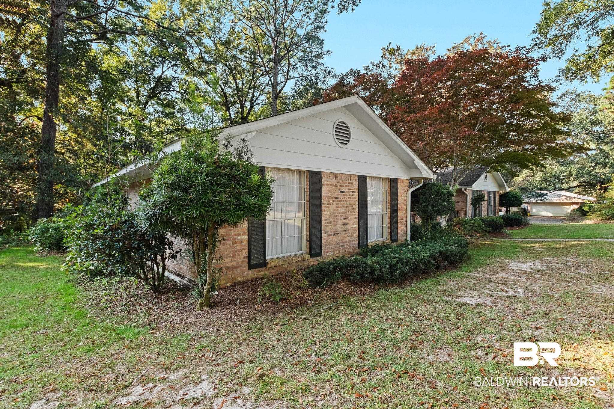 752 Evergreen Street Fairhope, AL 36532 - Photo 96 of 100 View of property exterior featuring a lawn and brick siding