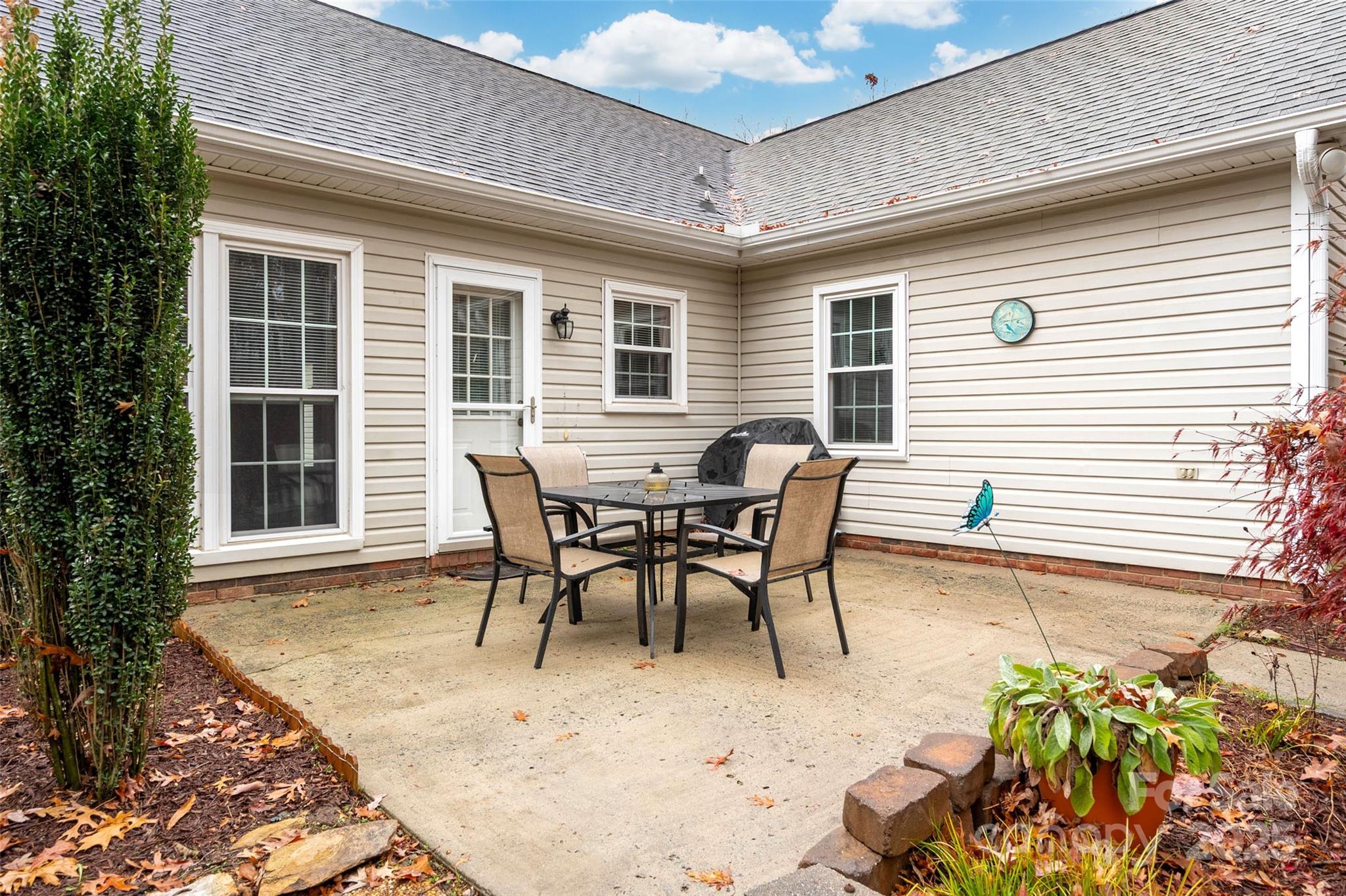 6045 Burnt Mill Run Matthews, NC 28104 - Photo 23 of 32 a view of a house with patio and a yard