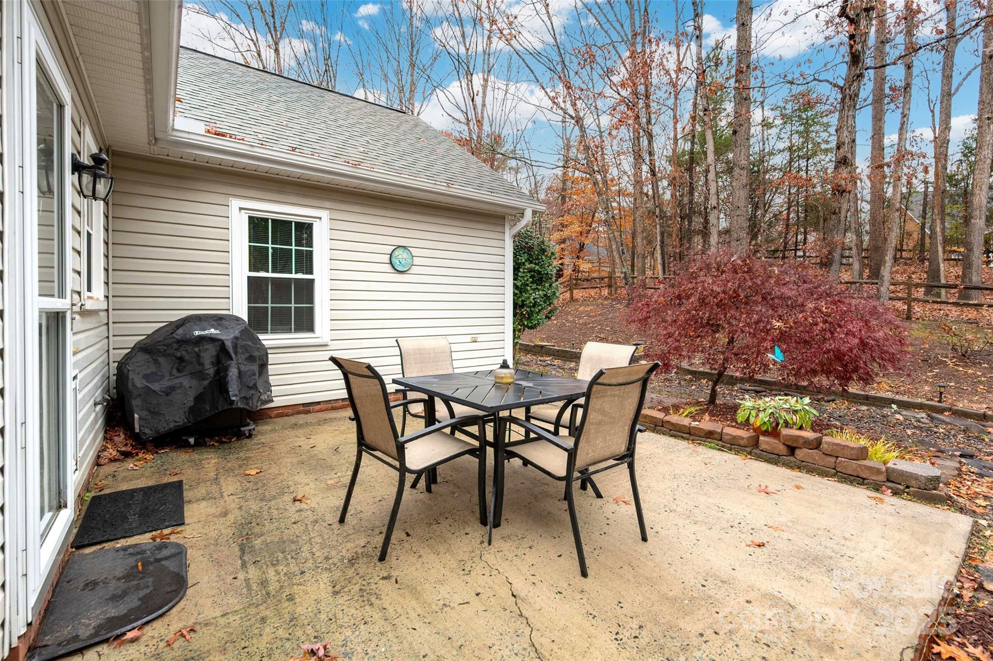 6045 Burnt Mill Run Matthews, NC 28104 - Photo 24 of 32 a backyard of a house with table and chairs