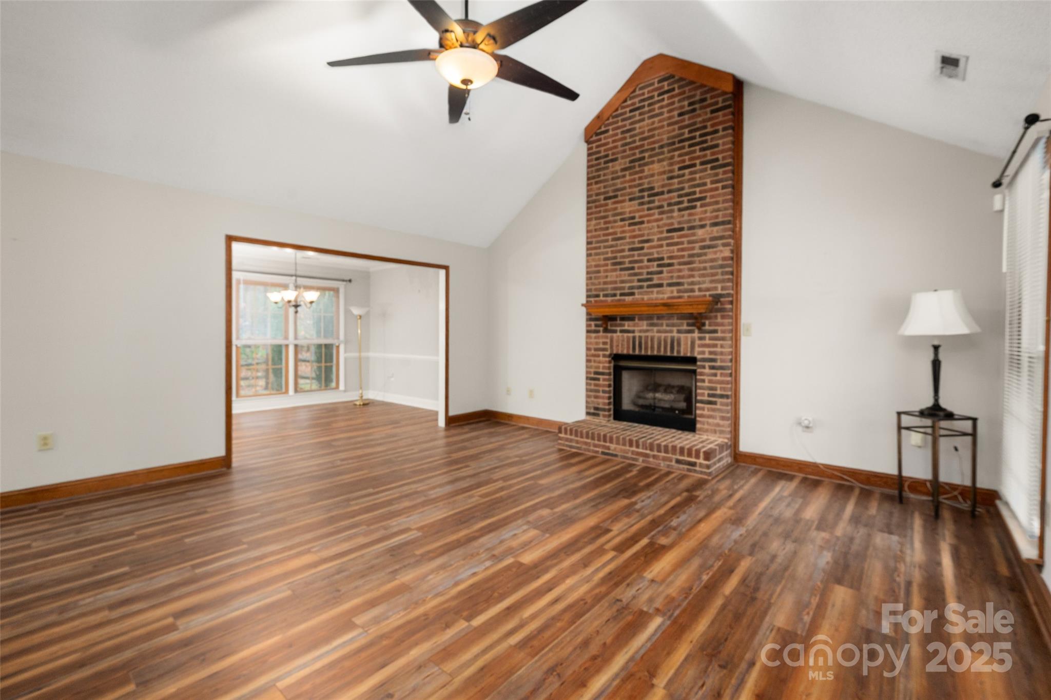 6045 Burnt Mill Run Matthews, NC 28104 - Photo 4 of 32 a view of empty room with wooden floor and fan