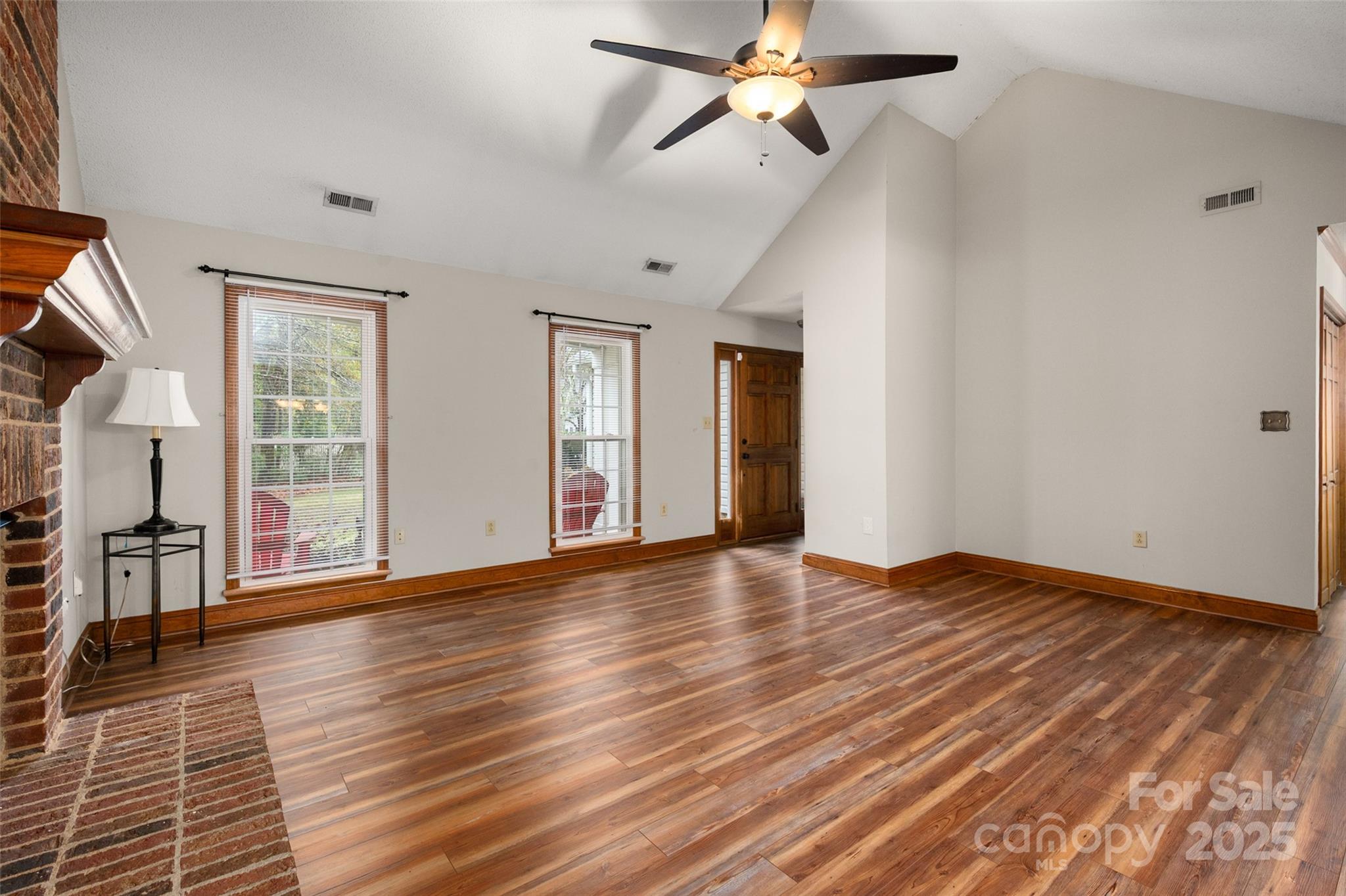 6045 Burnt Mill Run Matthews, NC 28104 - Photo 5 of 32 a view of empty room with wooden floor and fan