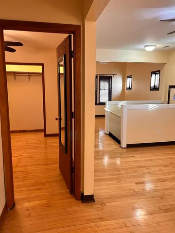 a view of a living room with furniture and wooden floor