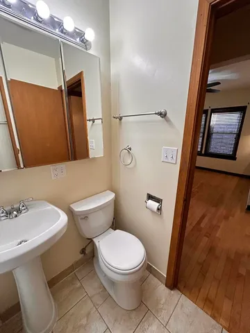 a white toilet sitting next to a bathroom sink