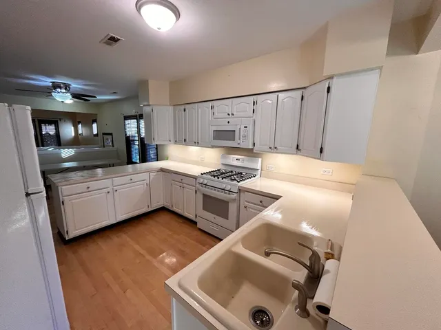 a kitchen with a sink appliances and cabinets