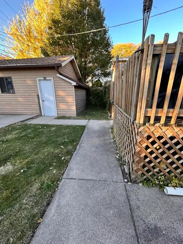 a view of a house with wooden fence