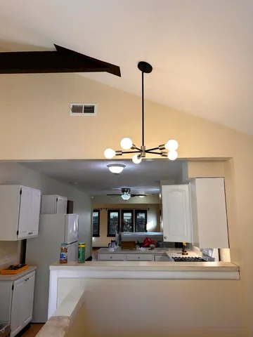 a kitchen with kitchen island stainless steel appliances a sink and cabinets