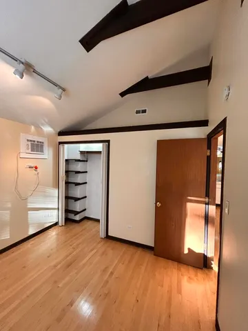 a view of an empty room and wooden floor