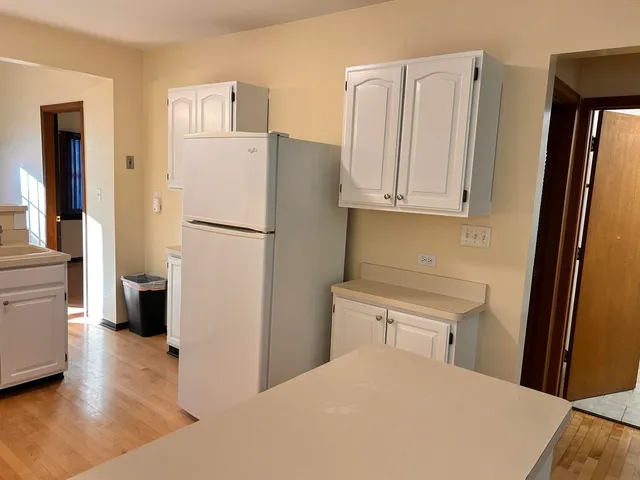 a white refrigerator freezer sitting in a kitchen