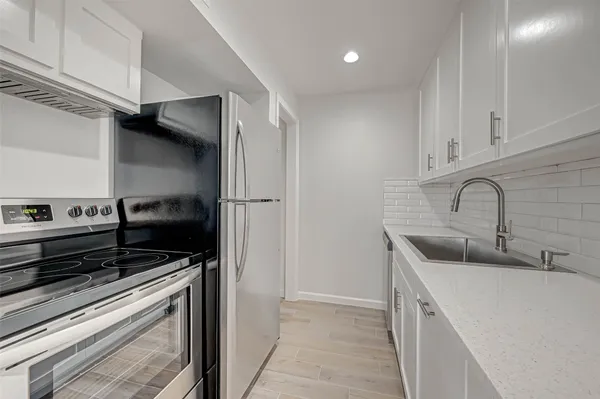 a kitchen with stainless steel appliances a sink dishwasher and a stove