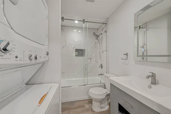 a bathroom with a sink toilet and shower