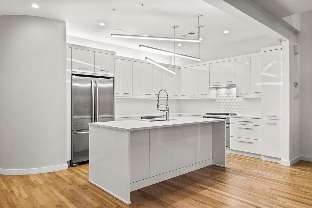 3344 Miro Place Dallas, TX 75204 - Photo 17 of 38 a kitchen with stainless steel appliances a sink cabinets and wooden floor