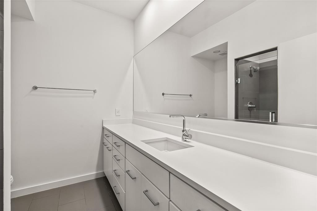 3344 Miro Place Dallas, TX 75204 - Photo 6 of 38 a bathroom with a sink and a large mirror