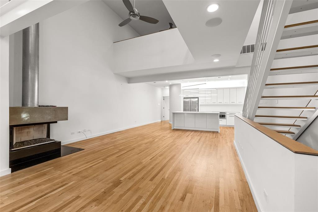3344 Miro Place Dallas, TX 75204 - Photo 7 of 38 a view of a livingroom with wooden floor and staircase