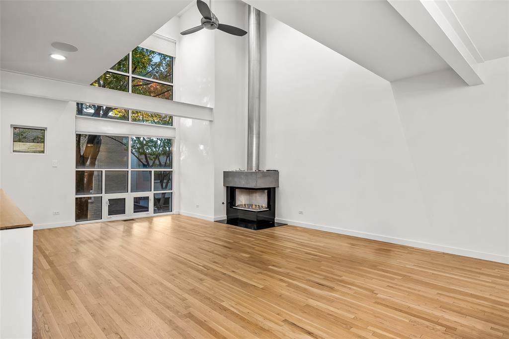 3344 Miro Place Dallas, TX 75204 - Photo 9 of 38 a view of an empty room with wooden floor and a window