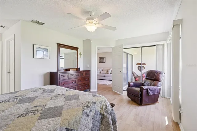 a bedroom with a bed and dresser with mirror