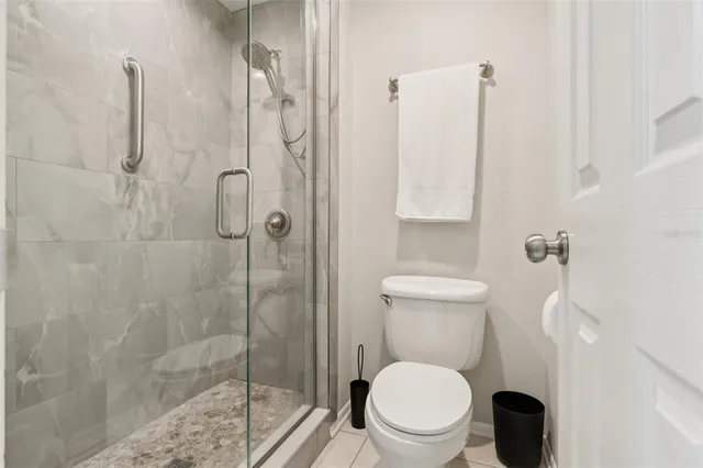 a white toilet sitting next to a bathroom sink