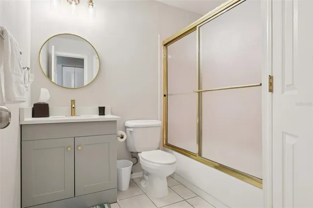 a bathroom with a toilet a sink and a mirror