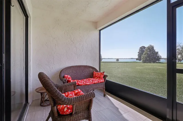 a living room with furniture and a floor to ceiling window