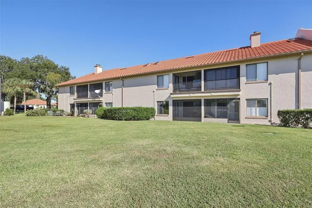 an aerial view of a house with a garden and lake view