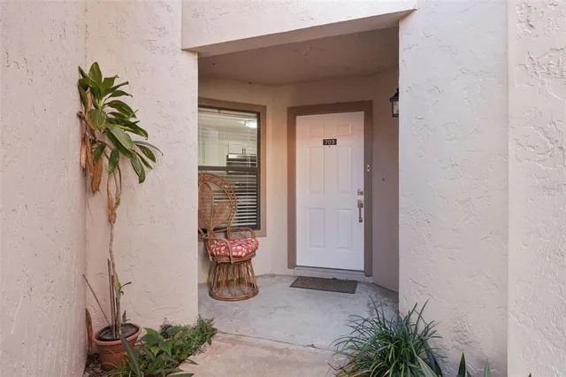 a view of a hallway with potted plants