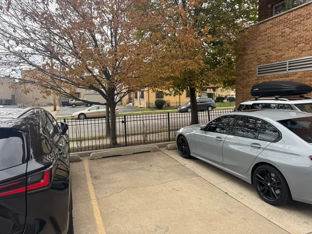 a view of a cars park in front of a house