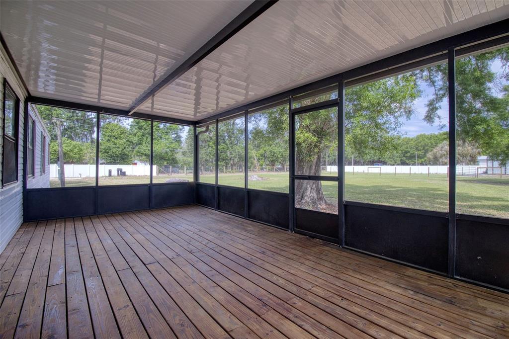 6804 Stafford Road Plant City, FL 33565 - Photo 18 of 24 a view of a room with wooden floor and outdoor space