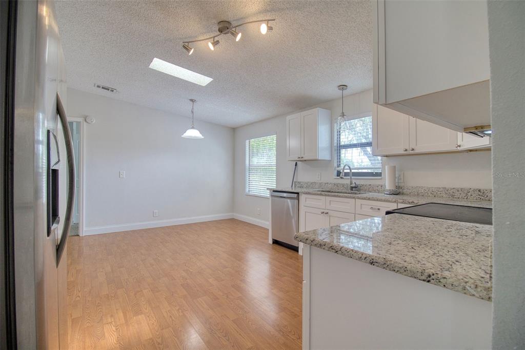 6804 Stafford Road Plant City, FL 33565 - Photo 6 of 24 a kitchen with stainless steel appliances granite countertop a refrigerator a sink a stove and oven